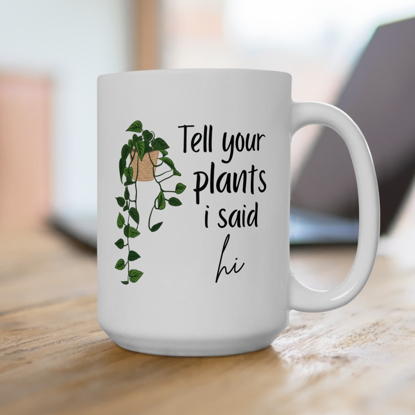 Tell your plants i said hi white ceramic coffee mug on a table.