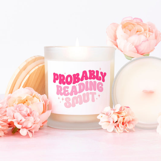 Probably reading smut pink retro style font funny quote. Pink wick candle in a frosted glass. 